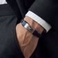 Man wearing Emporio Armani navy braided leather bracelet with blue steel bars with a formal suit